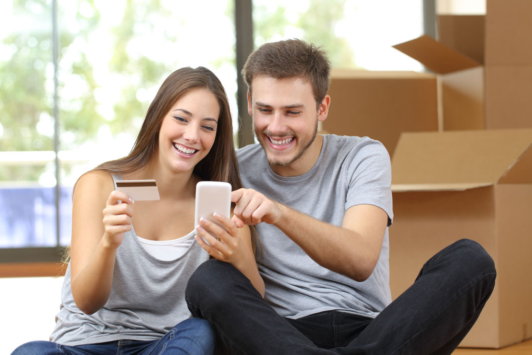 Two People Looking at Card and Phone